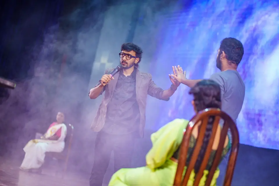 Fazil Basheer performing live mentalism on stage at Tricks Mania